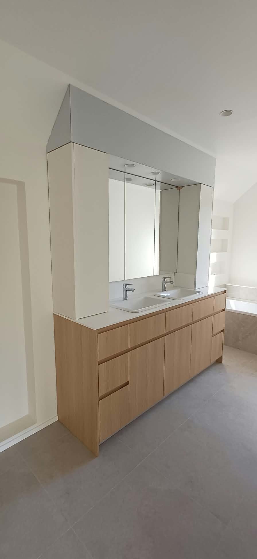 Meuble double vasque en bois clair avec rangements et miroirs